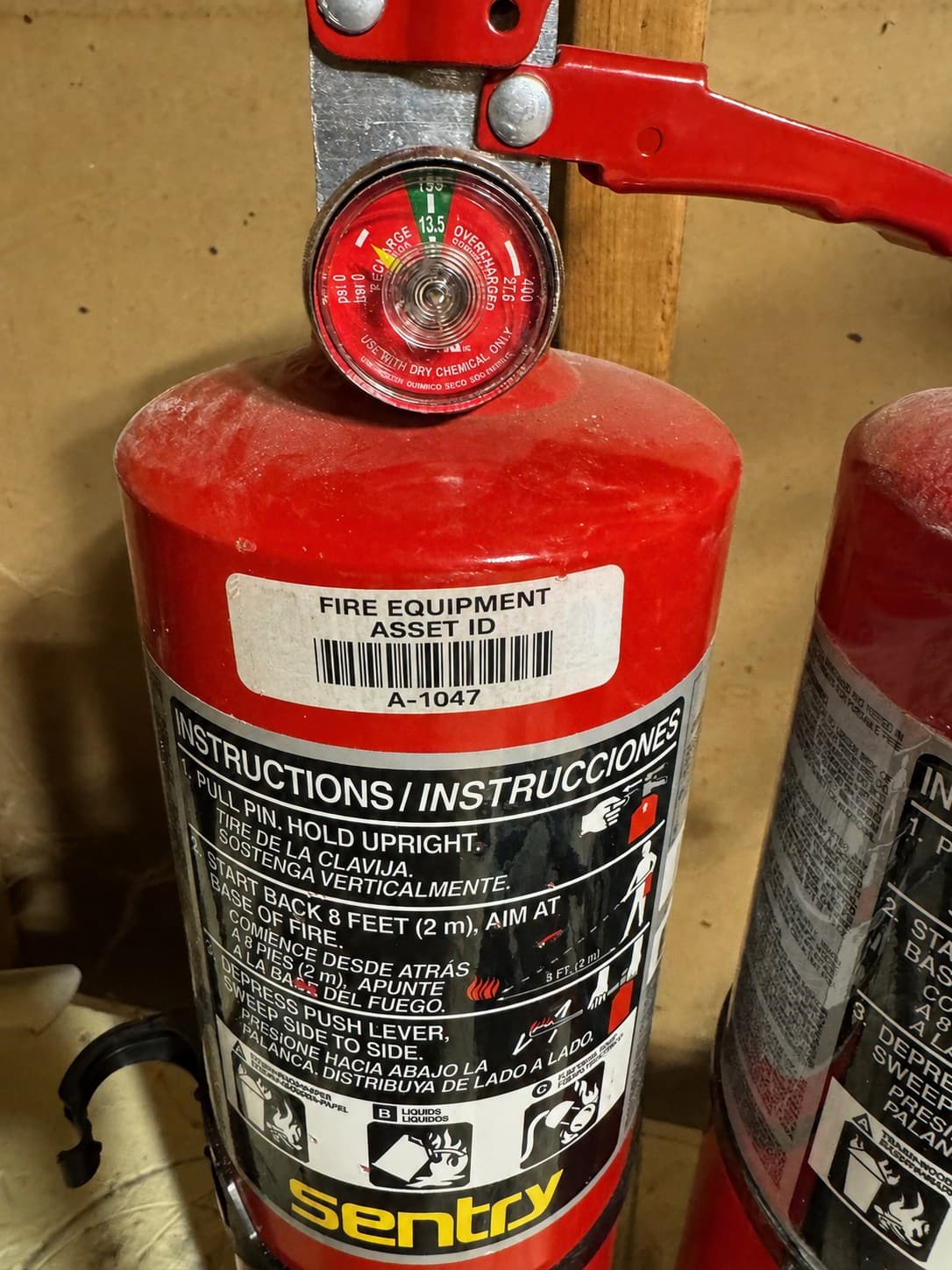 Fire extinguisher with a separately applied barcode asset label